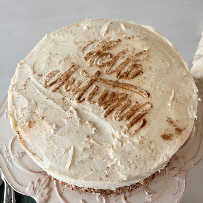 Hello Autumn with cinnamon and icing on white round cake