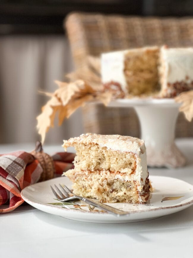 slice of harvest cake with cake stand in background