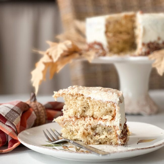 slice of harvest cake with cake stand in the back ground