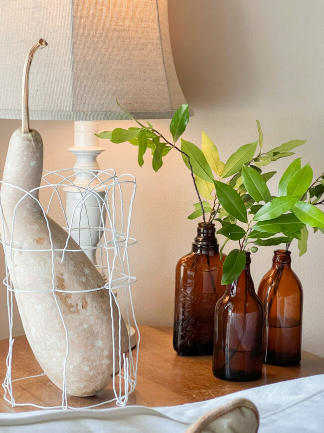 3 amber bottles with green stems, lamp and gourd 