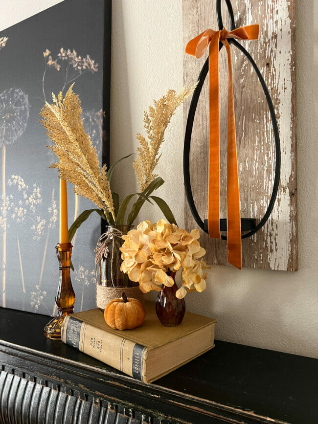 gold book with amber glass and floral stems