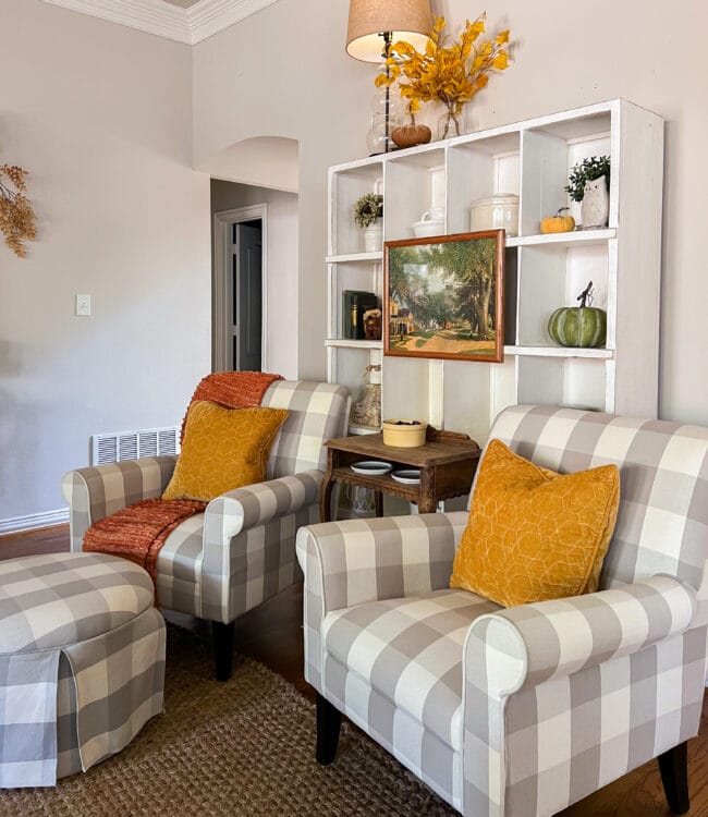 checked chairs in front of fall decorated cubby shelf