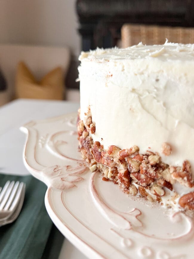 white cake with chopped pecans on the side