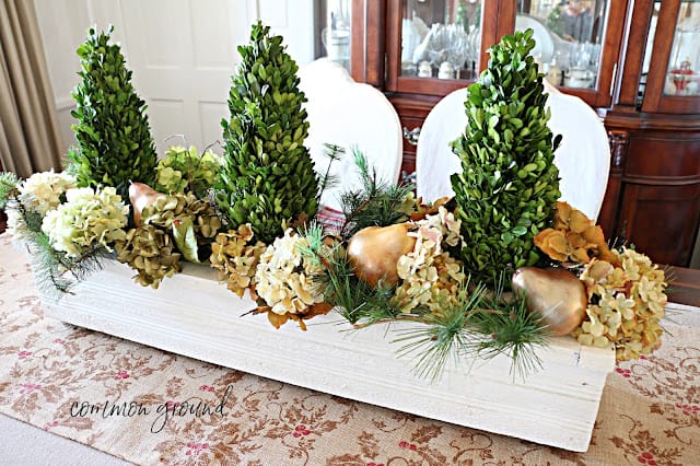 white box as centerpiece with boxwood trees , flower and gold pears