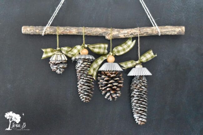 4 pinecones hanging from branch with green checked bows