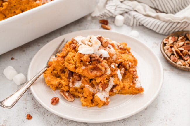 sweet potato casserole on a white plate with fork