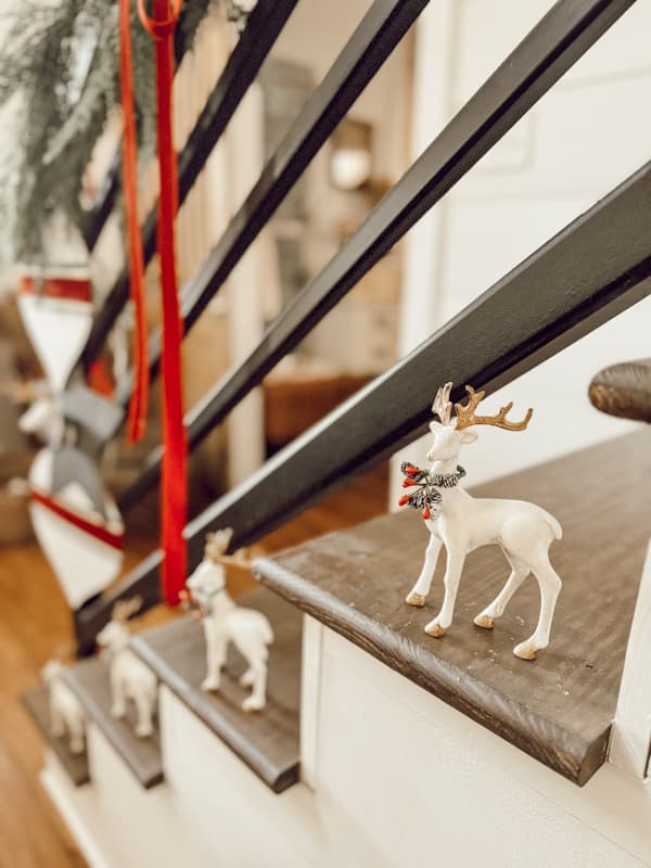 white reindeer sitting on stairs