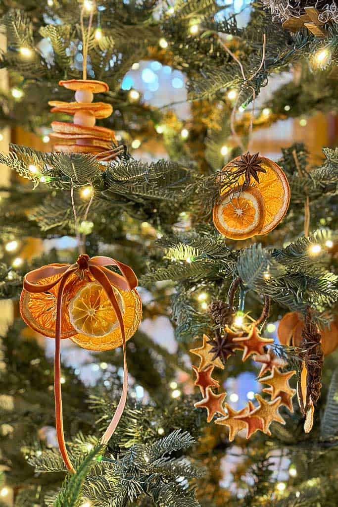 CHristmas tree with dried orange ornaments and ribbon