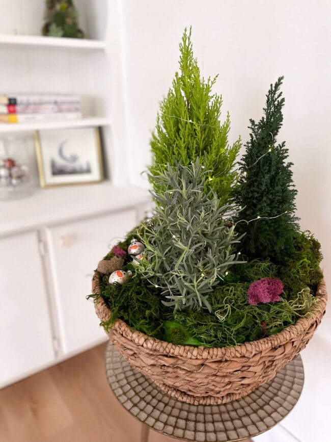 3 small trees in a basket with snowmen ornaments