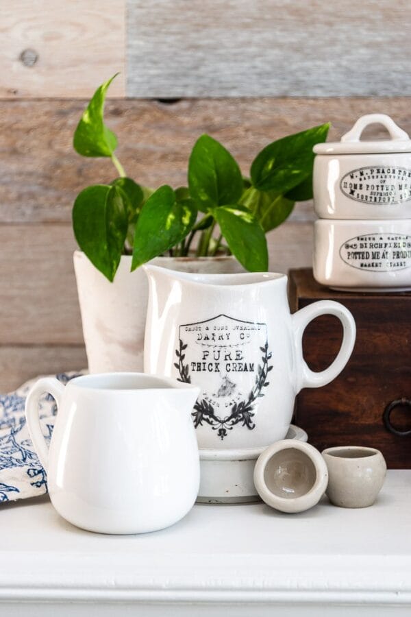 white ironstone with antique inspired labels and a plant