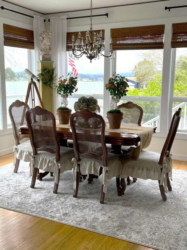 dining table in front of windows with telescope in corner