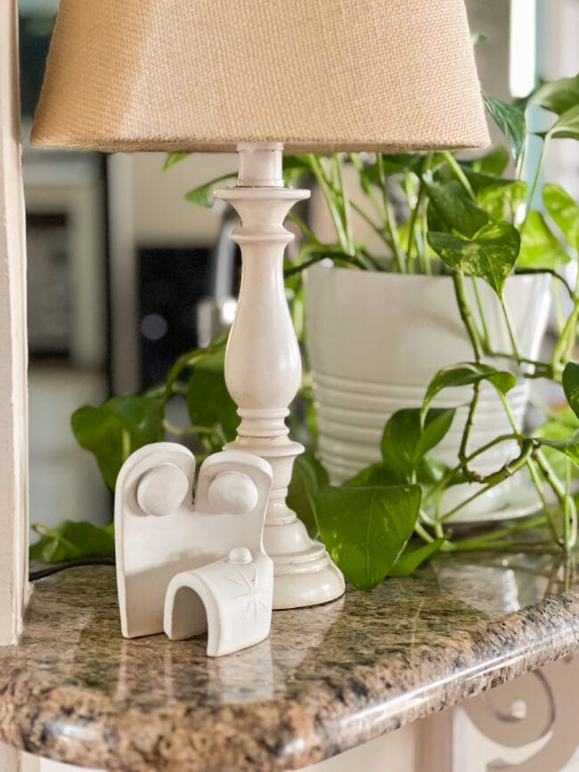 small ceramic manger scene with plant and lamp on kitchen counter