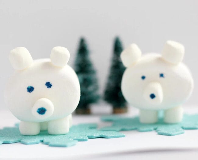 2 white marshmallow polar bear craft with small trees in background