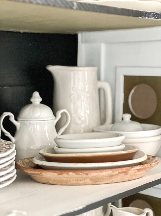 stack of ironstone bowls with creamer and white pitcher