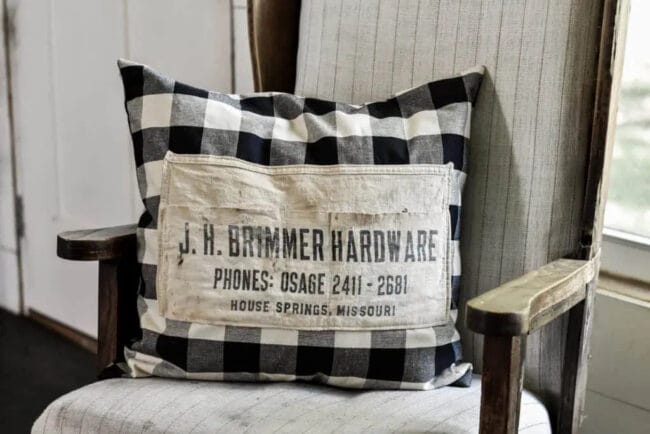 black and white checked pillow with vintage apron sewn on front