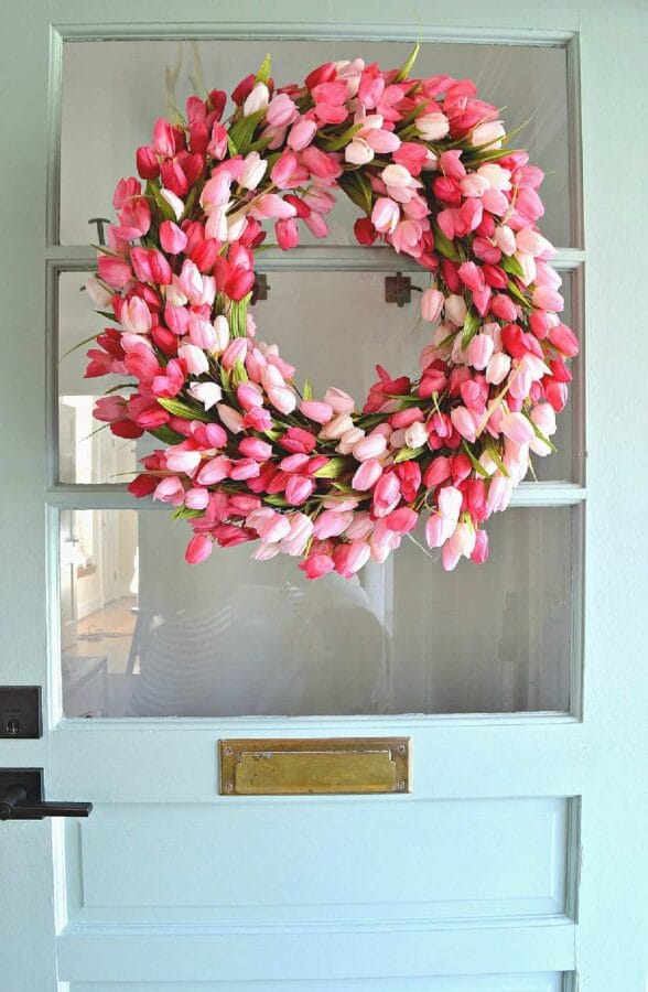 pink tulip wreath hanging on glass door