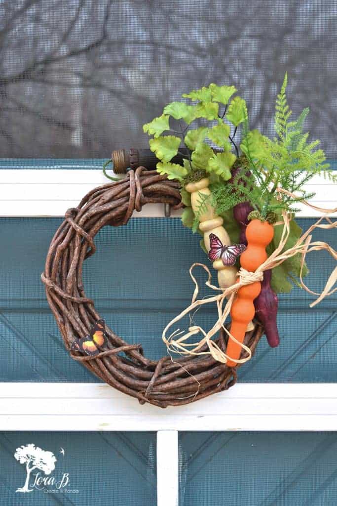 grapevine wreath with DIY spindle stick carrots in orange and yellow