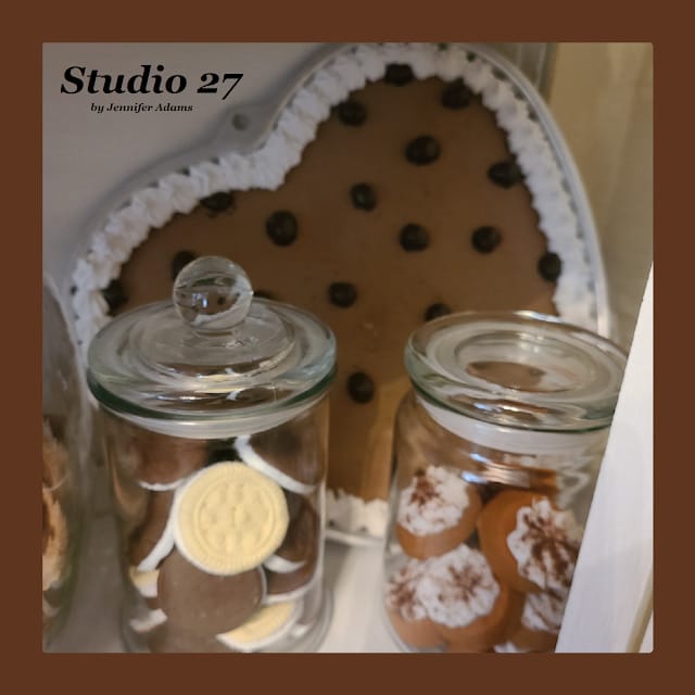 faux chocolate chip heart cookie behind 2 jars with cookies