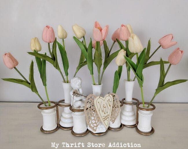 white vintage bud vases with pink tulips and a heart