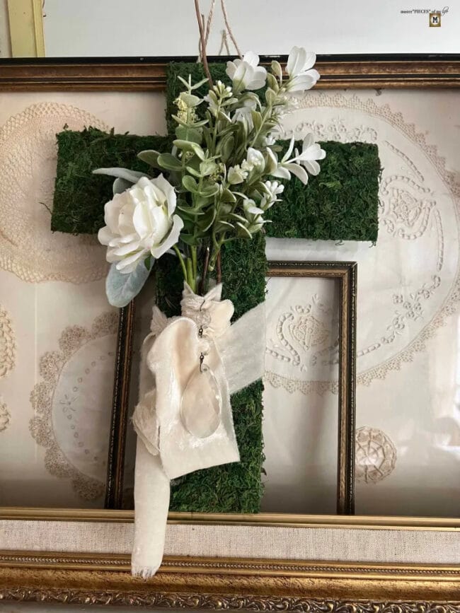 moss cross with white flowers