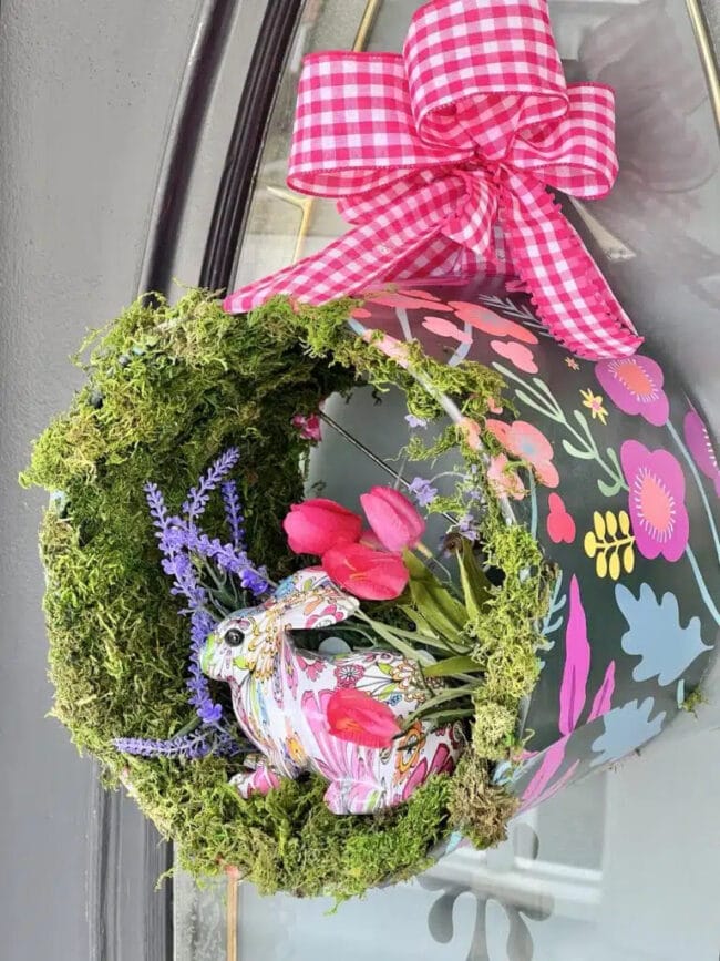 spring looking wreath made from a lampshade with a bunny, tulips and pink checked ribbon