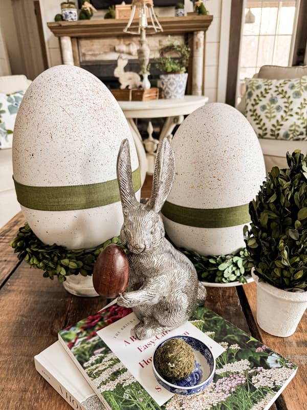 extra large white speckled eggs with green ribbon and a silver rabbit