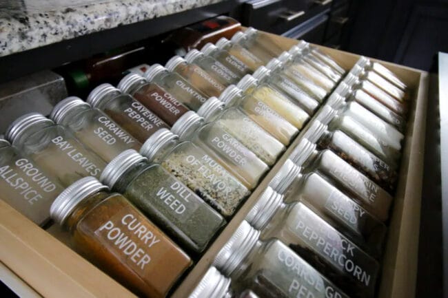 3 rows of spice jars in a drawer