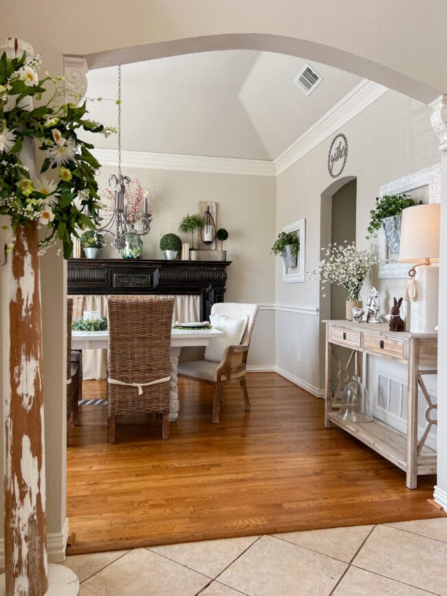 fdining room with column, table and black mantel for spring