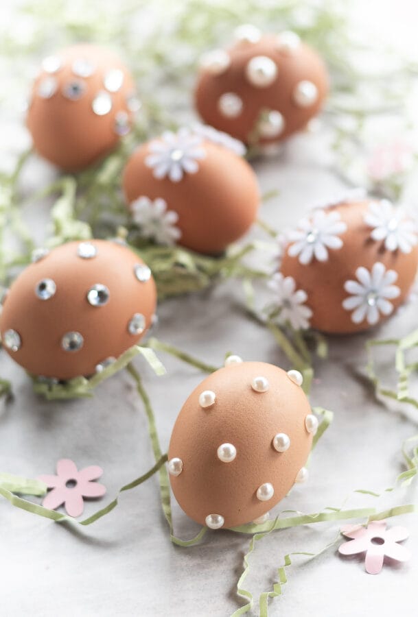 brown eggs with white pearls, flowers or rhinestones attached