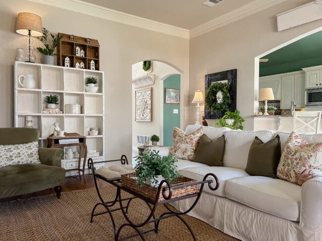 living room with sofa, coffee table and cubby shelf