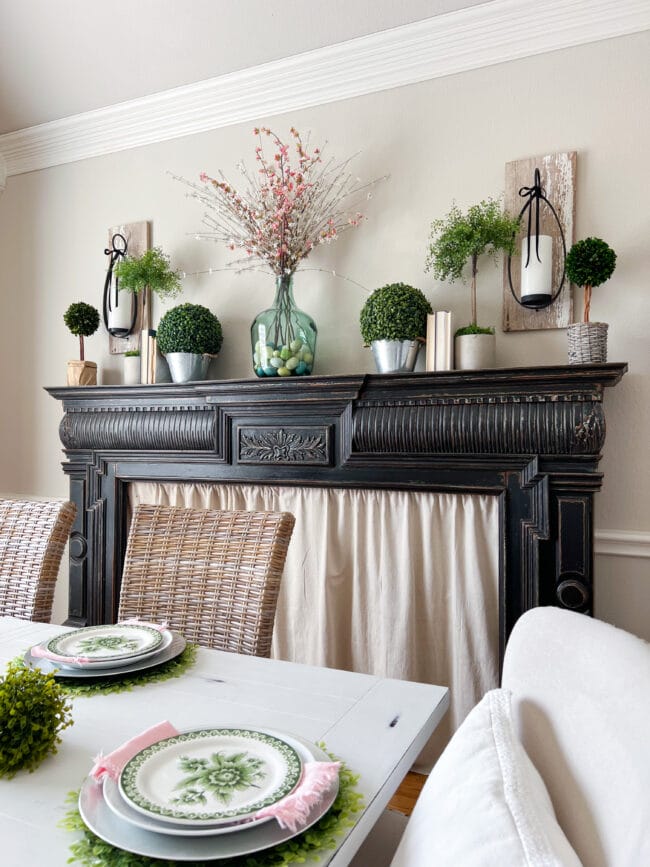 black mantel with topiaries