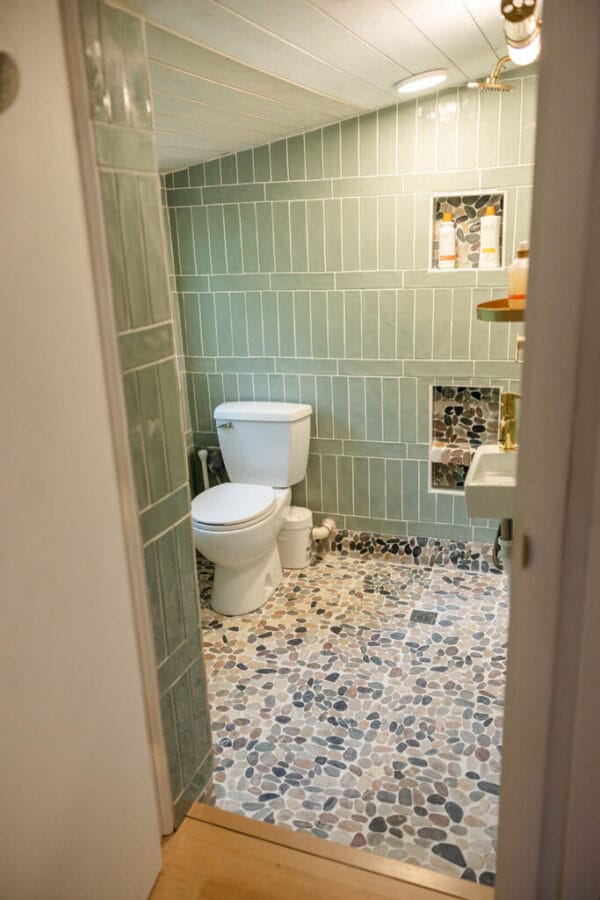 green tile walls in small bath with toilet and sink included