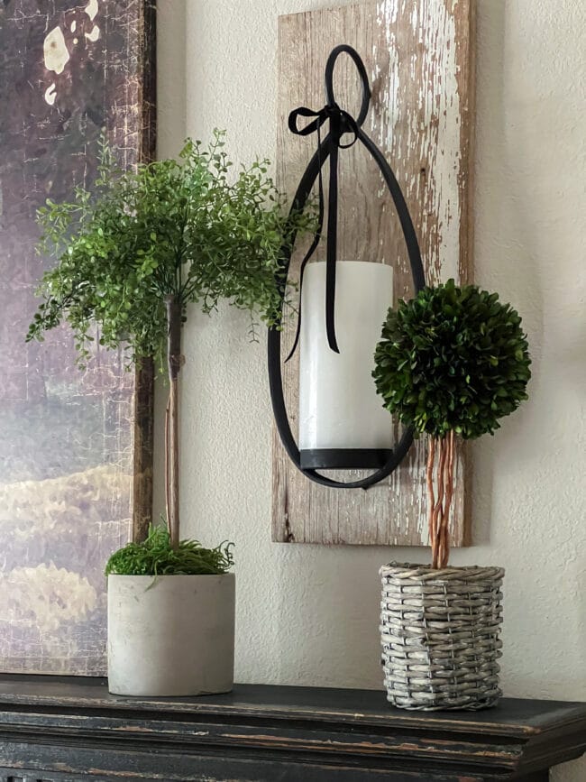 vintage board made into candle sconce with 2 topiaries