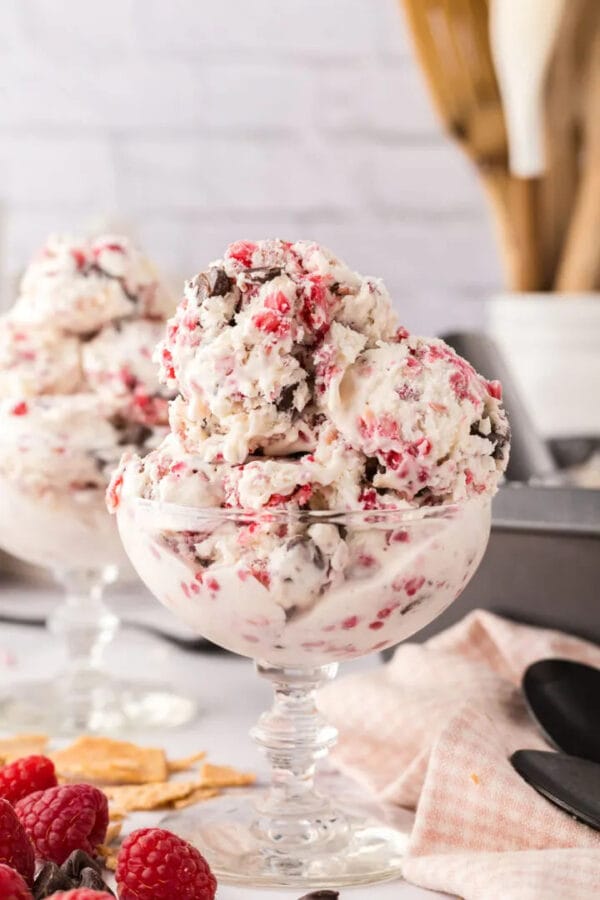 large scoops of raspberry and chocolate ice cream in clear glass