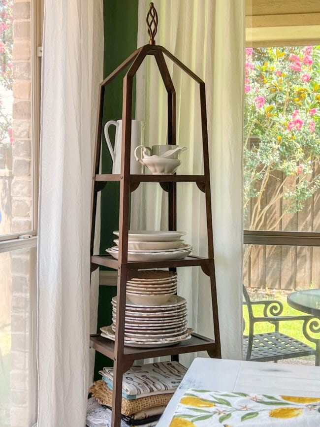 metal tower with plates in front of windows to patio