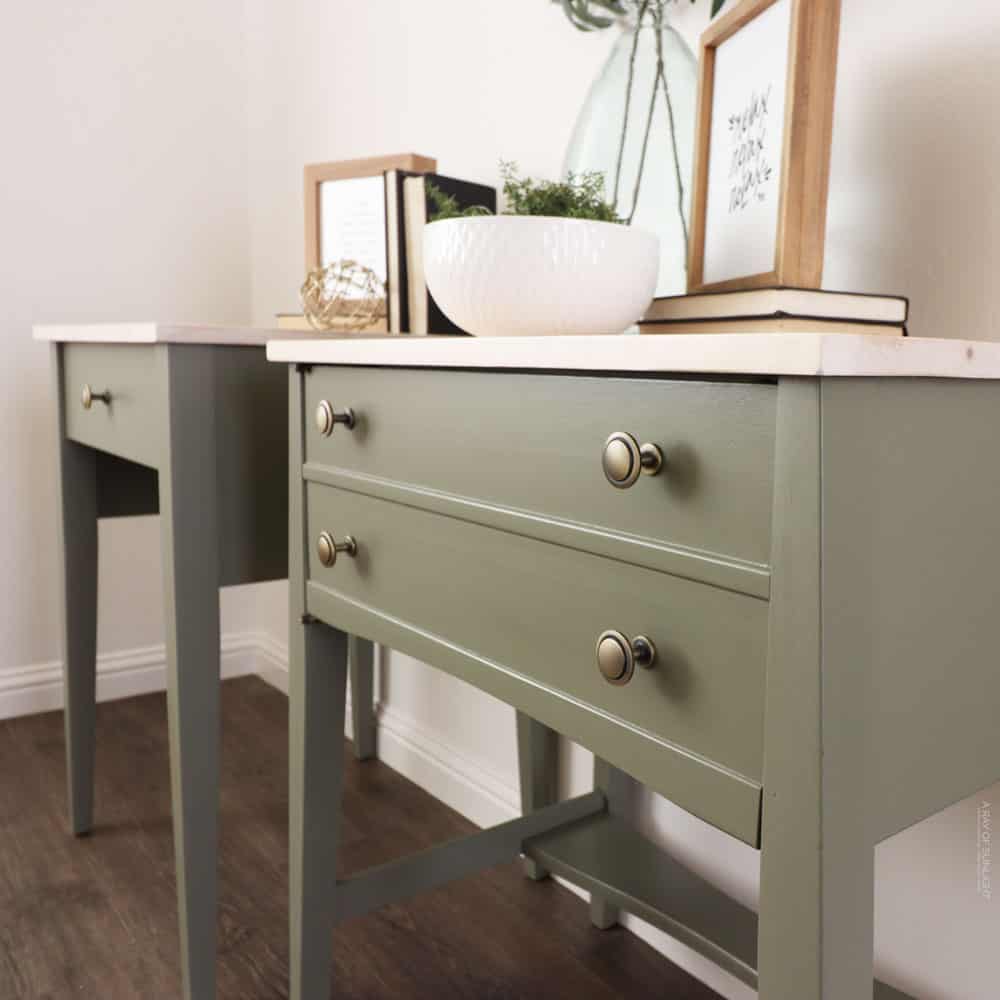 two green sewing machines turned into side tables