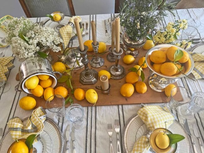 lemons on a tablescape with candles and plates