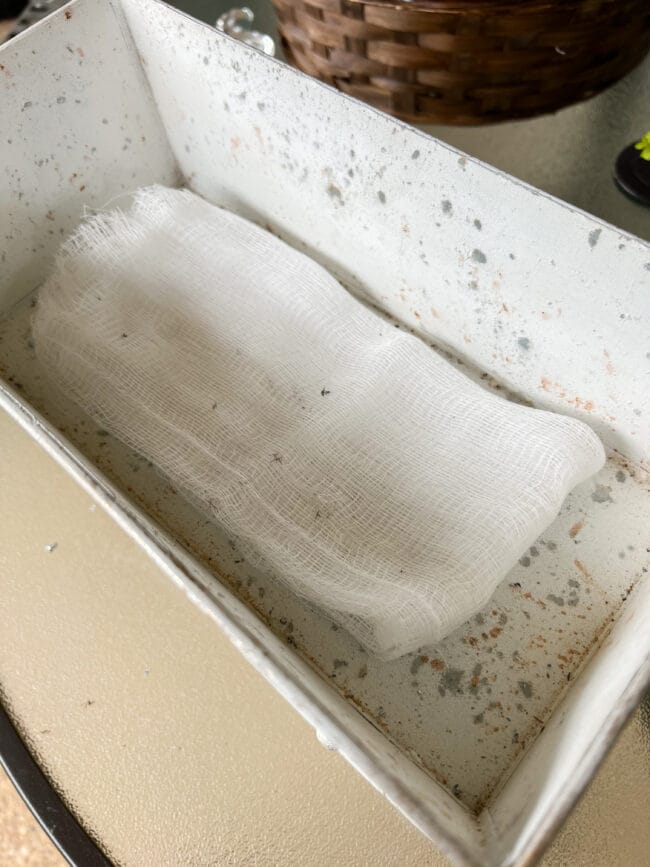 cheesecloth layered inside a white container