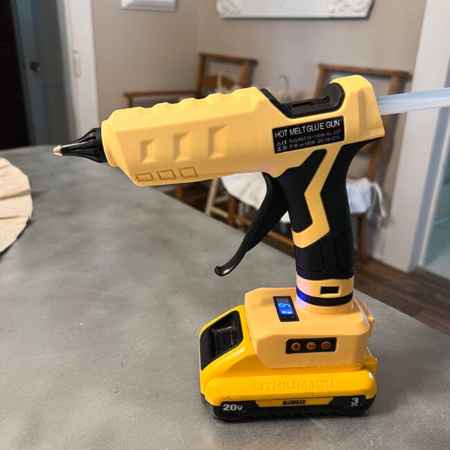 yellow cordless hot glue gun sitting on a table