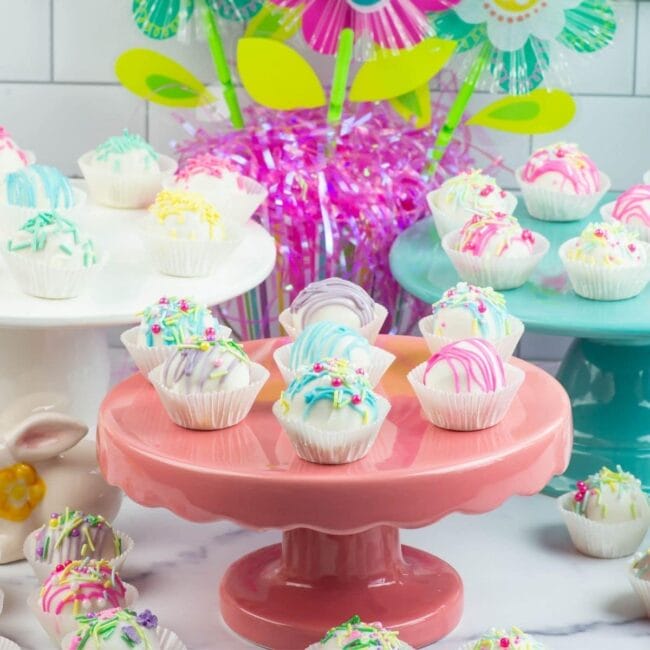table with bright cake plates and Easter cake balls on otp