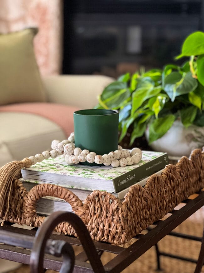 scalloped tray basket with plant, candle, books and beads