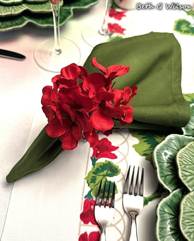red geranium napkin rings on a green napkin 