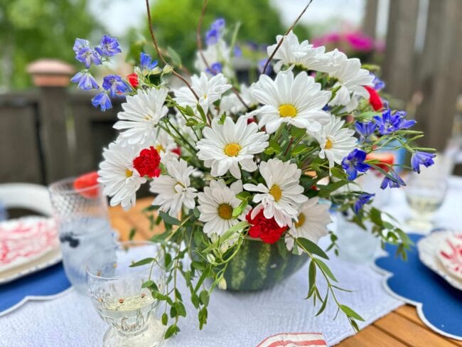 Bouquet of red, white and blue flowers inside a watermelon