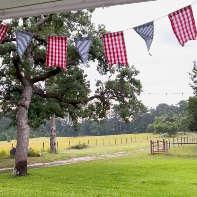 pasture with a patriotic banner hanging on the edge of the porch