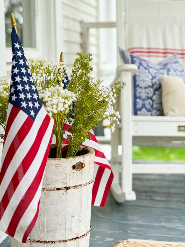 Vintage white ice cream maker with faux greenery and a US flag