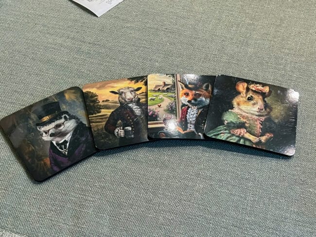 4 animal coasters lined up on green fabric