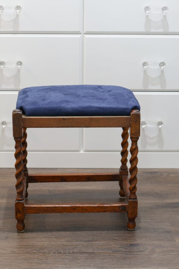 wooden stool with blue seat