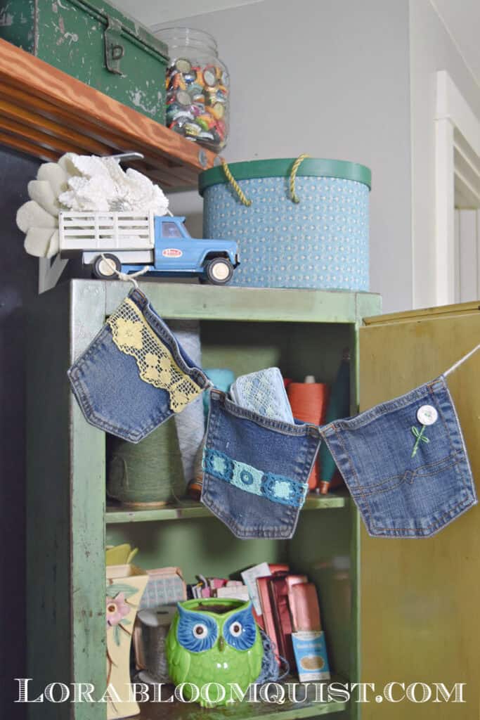 green school locker with denim pocket banner, and trucks, boxes, owl vase and bottle caps in a jar