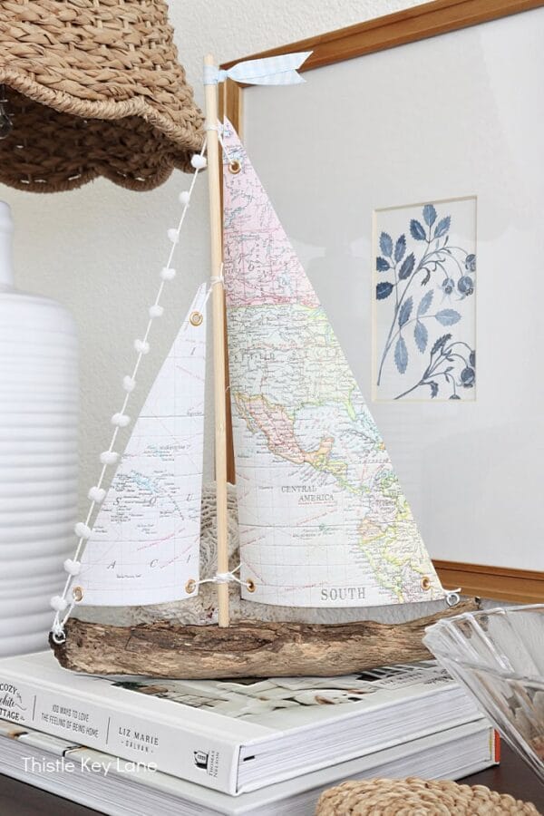 sailboat made with map paper sails and driftwood