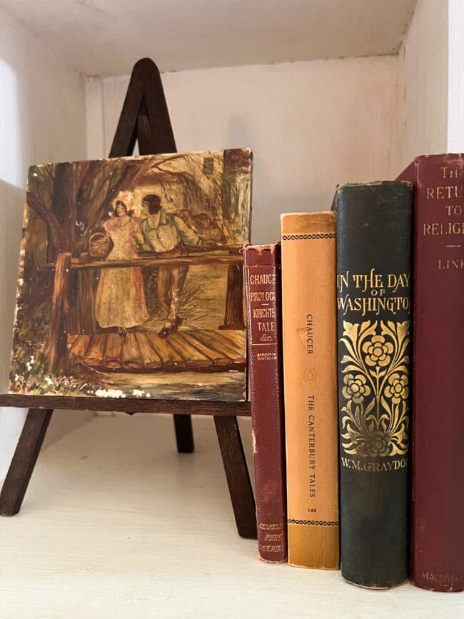 small easel with vintage tile and fall colored books